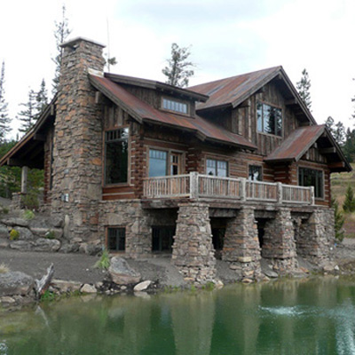 Big Sky Custom Log Home With Incredible Rock Work and Pond